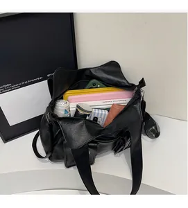 Internal view of large capacity black PU tote bag showing spacious storage for daily items