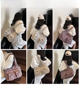 Detailed back view of model wearing multi-pocket retro leather tote bag on shoulder