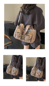Detail of vintage brown tote bag with metal ring buckles and soft leather texture