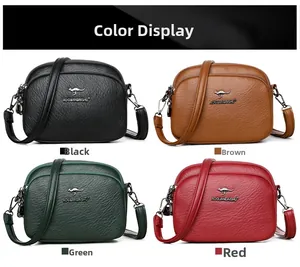 Detail view of the soft lychee grain texture and metal logo on a four-color leather bag