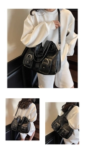 Detail view of large black leather tote bag with silver rings and adjustable strap