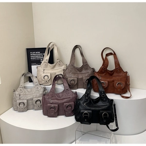 Detail of vintage tote bags in six colors with front buckle pockets and textured leather
