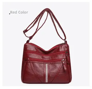 Close-up of wine red multi-layer crossbody bag with rhinestone details and soft PU leather