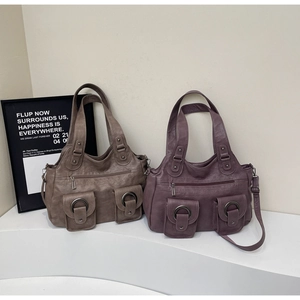 Detail of vintage tote bag with dual front magnetic pockets and faux leather texture