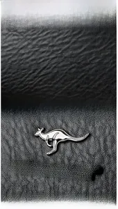 Detailed macro shot of premium black lychee grain leather and metallic kangaroo brand logo