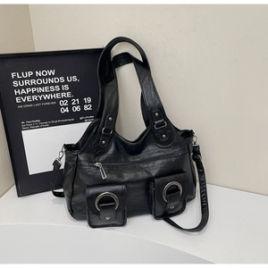 Detailed view of black retro PU tote bag with metal rings and magnetic front pockets