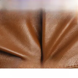 Close-up of soft brown leather texture showing scratch-resistant pebble grain details