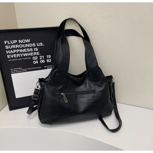 Detail of black PU leather tote bag back view showing functional horizontal zipper pocket