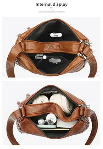 Detail view of large brown vintage shoulder bag showing internal compartments and storage capacity
