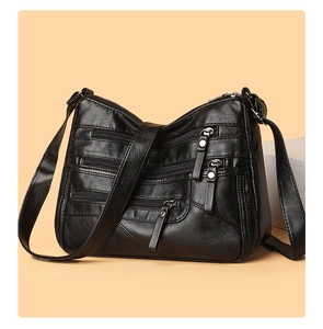 Detail of the high-quality soft black leather texture and multi-zipper pocket design