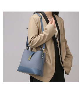 Detailed shot of Morandi blue textured tote bag with gold hardware and leather details