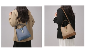 Detail of light blue and tan bucket bags with gold buckles and adjustable shoulder straps