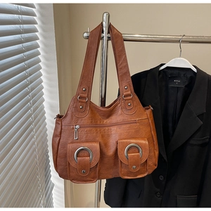 Macro shot of brown retro tote bag with vintage texture and silver ring buckles