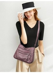 Detail of soft purple multi-zipper crossbody bag with adjustable shoulder strap