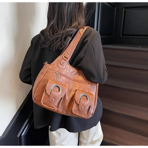 Brown vintage faux leather tote bag with silver metal rings and front pockets details
