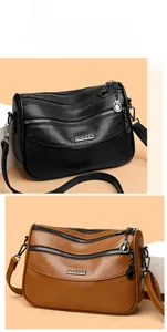 Close-up of multi-layer zipper crossbody bags in black and brown textured PU leather
