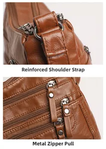 Detail view of reinforced stitching and silver zipper hardware on a brown leather bag