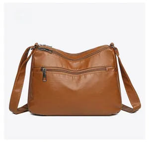 Rear view of brown soft leather crossbody bag showing back zipper pocket and stitching