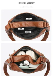 Detail view of brown pebbled leather bag interior with double main compartments and zipper pocket