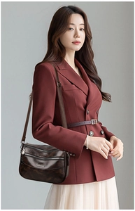 Detail view of multi-layer vintage dark brown leather crossbody bag with metal logo