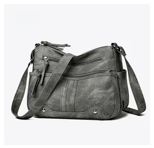 Vue latérale du sac bandoulière gris multi-poches avec texture vintage lavée