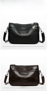 Detail view of multi-layer cross-body bags in black and leopard print with metal zippers