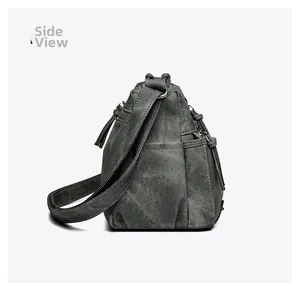 Vue latérale du sac bandoulière vintage en toile gris foncé avec bandoulière réglable