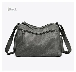 Vue arrière du sac bandoulière gris avec poches zippées et compartiments latéraux
