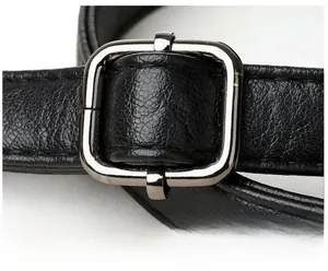 Macro detail of adjustable black leather strap with polished silver metal buckle