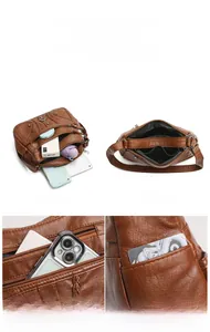 Detailed view of brown lychee grain leather crossbody bag with multi-layer storage compartments