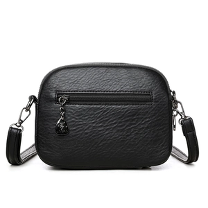 Classic black pebbled leather crossbody bag with metal zipper and decorative pendant