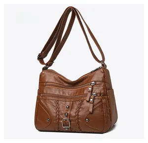 Micro side view of vintage brown woven leather crossbody bag with multiple zippers