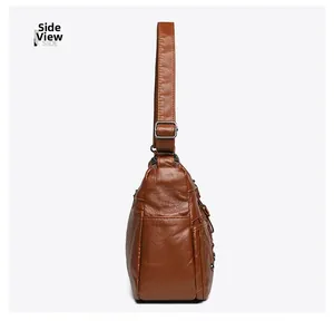 Side view of brown woven leather crossbody bag showing dual zipper compartments and pockets