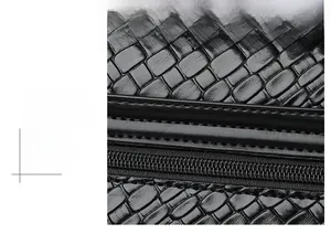 Close-up of black leather handbag featuring woven embossed texture and precision stitching