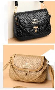 Detail of woven texture flap bags with golden kangaroo logo and adjustable shoulder straps