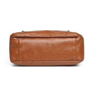 Bottom view of brown leather shoulder bag with multi-pocket design and textured finish