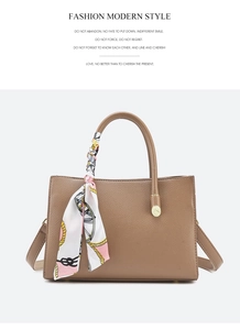 Brown lychee grain leather handbag detail featuring decorative scarf and gold hardware