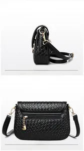 Detail of black woven shoulder bag showing golden hardware and back zipper pocket