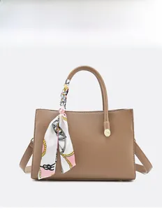 Brown lychee leather handbag with decorative patterned scarf handle and detachable strap