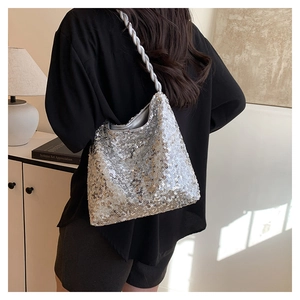 Detail of silver sequined handbag with thick twisted rope shoulder strap texture