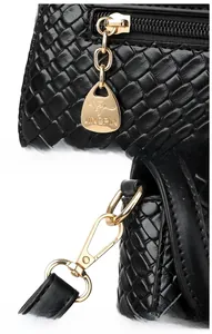 Detail of glossy black woven textured PU leather bag with premium gold hardware and zipper