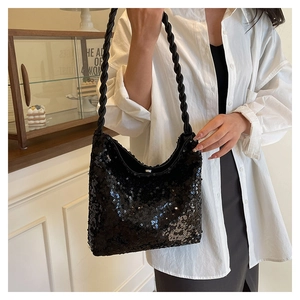 Detail of black sequined hobo bag featuring a unique thick braided leather shoulder strap