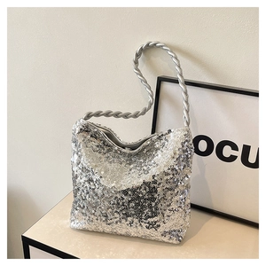 Detail of silver sequin handbag featuring a unique metallic twisted rope handle design