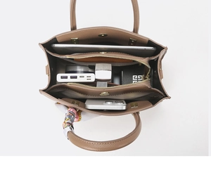 Internal view of brown pebble leather handbag showing spacious multi-compartment storage