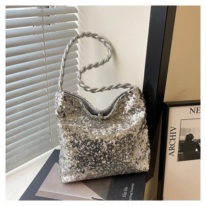 Close-up of sparkling silver sequin handbag with braided handle in natural light