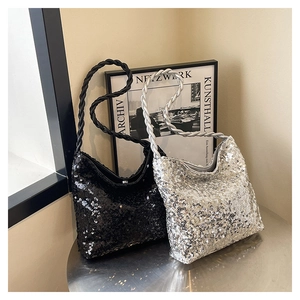 Detail of sequined shoulder bags with thick woven ropes in black and silver finishes