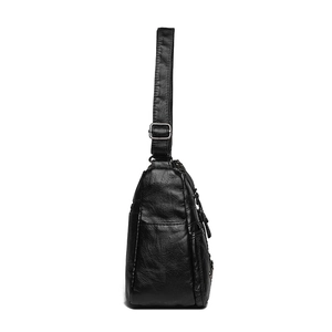Black woven textured leather crossbody bag with adjustable shoulder strap and side zipper pocket