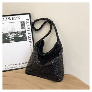 Close-up of black sequined shoulder bag with a thick twisted rope woven strap design