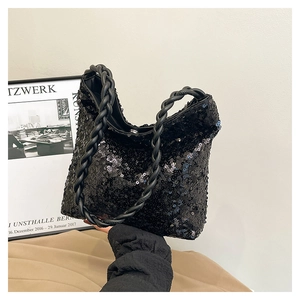 Detailed view of the black sequined handbag with a hand-woven braided handle design