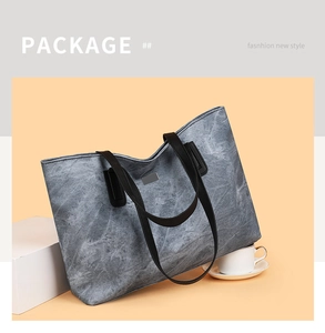 Close-up of large marble texture tote bag with black straps and minimalist front logo